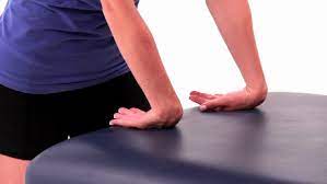 Wrist extensors stretching with the use of a table